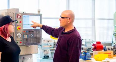 photo - students and faculty in the aerospace manufacturing lab
