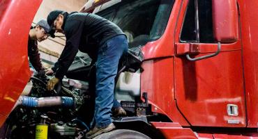 photo - students working on a 18 wheeler truck engine