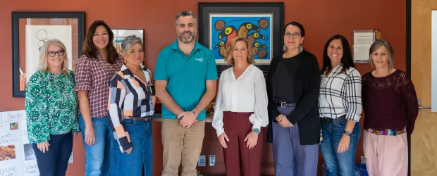College and Hydro One staff standing together in the updated smudging room supporting campus Indigenization.