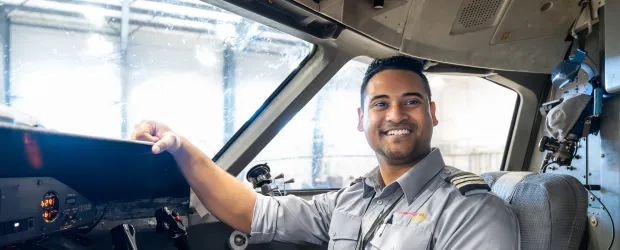 Aviation Flight Management graduate in cockpit of Dash 8, representing path to first officer with North Star Air.