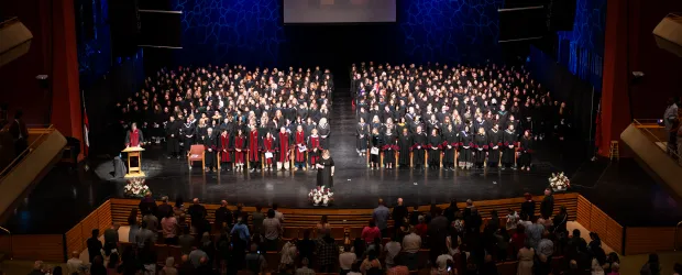 Graduates and faculty gather on stage during Confederation College’s 2026 convocation ceremony