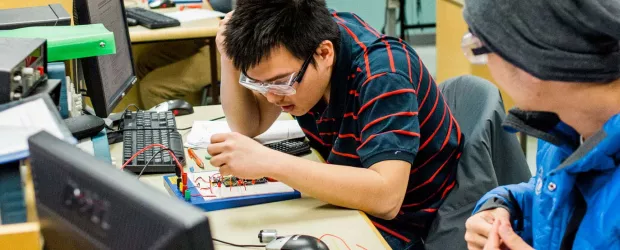 banner photo - international student working in electronics lab