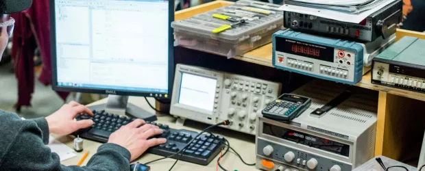 photo - student coding logic at an electronics workstation