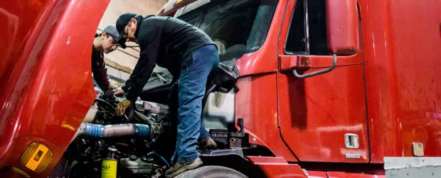 photo - students working on a 18 wheeler truck engine