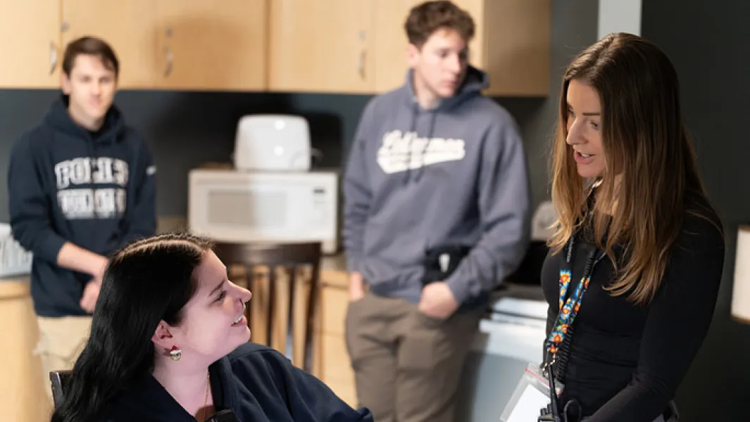 Instructor speaking with students during an in-class discussion