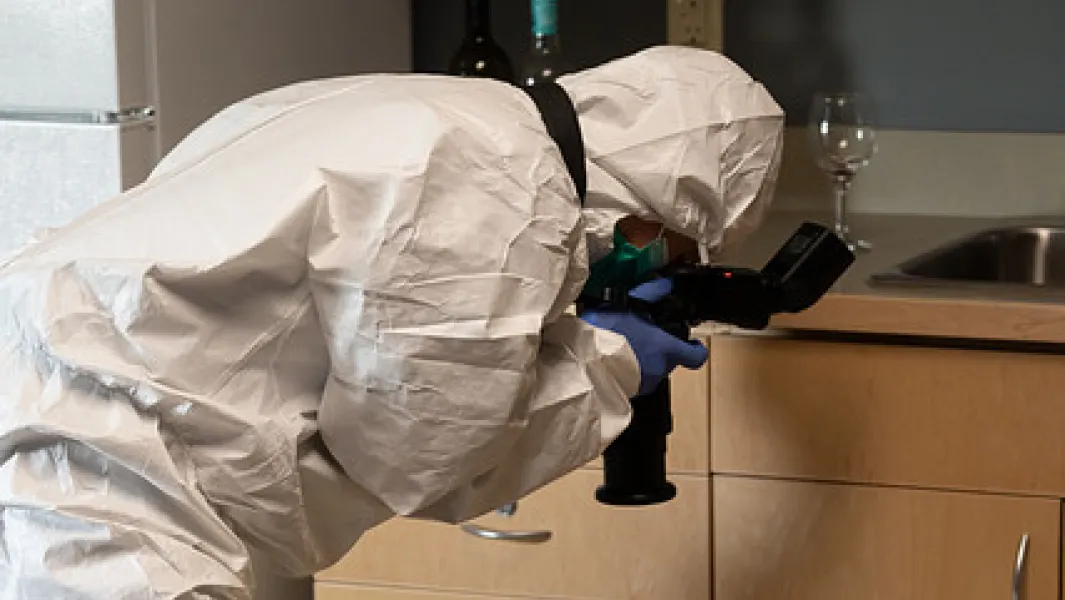 Forensic investigator documents evidence in a simulated crime scene