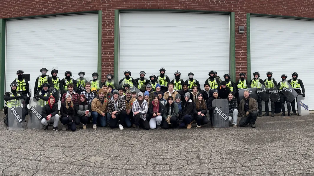Police and students pose together during a public order training exercise