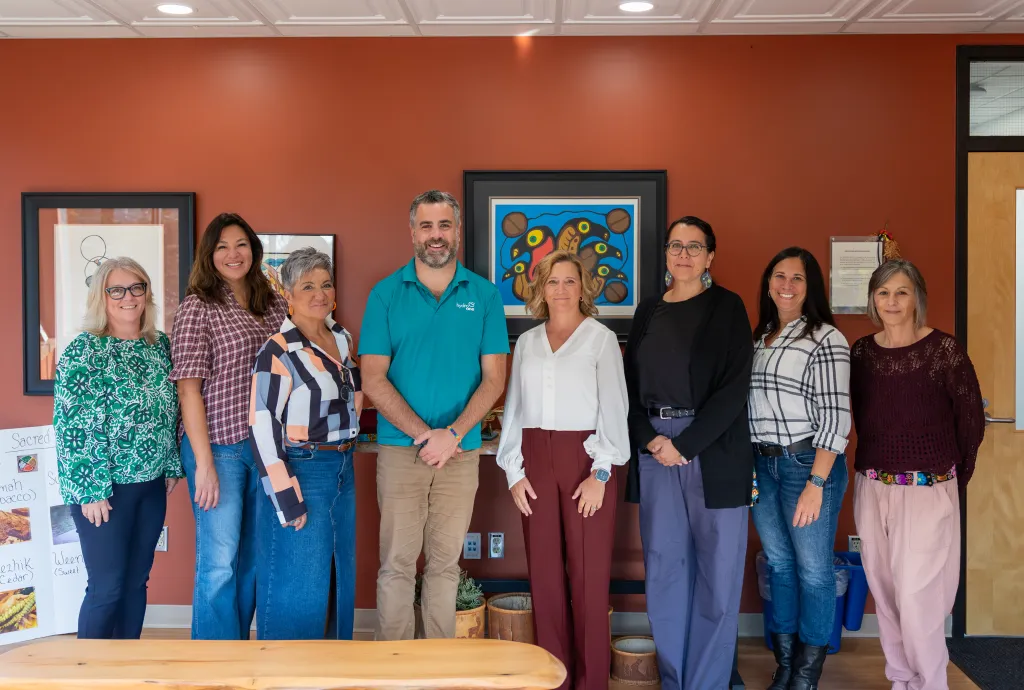 College and Hydro One staff standing together in the updated smudging room supporting campus Indigenization.