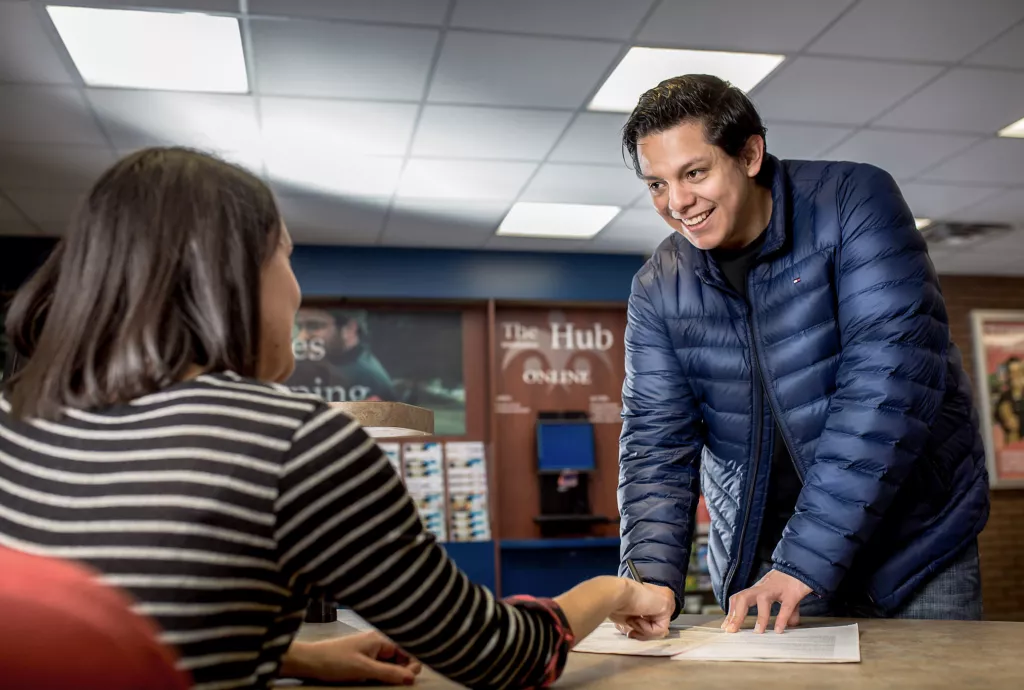 College staff greeting a new student