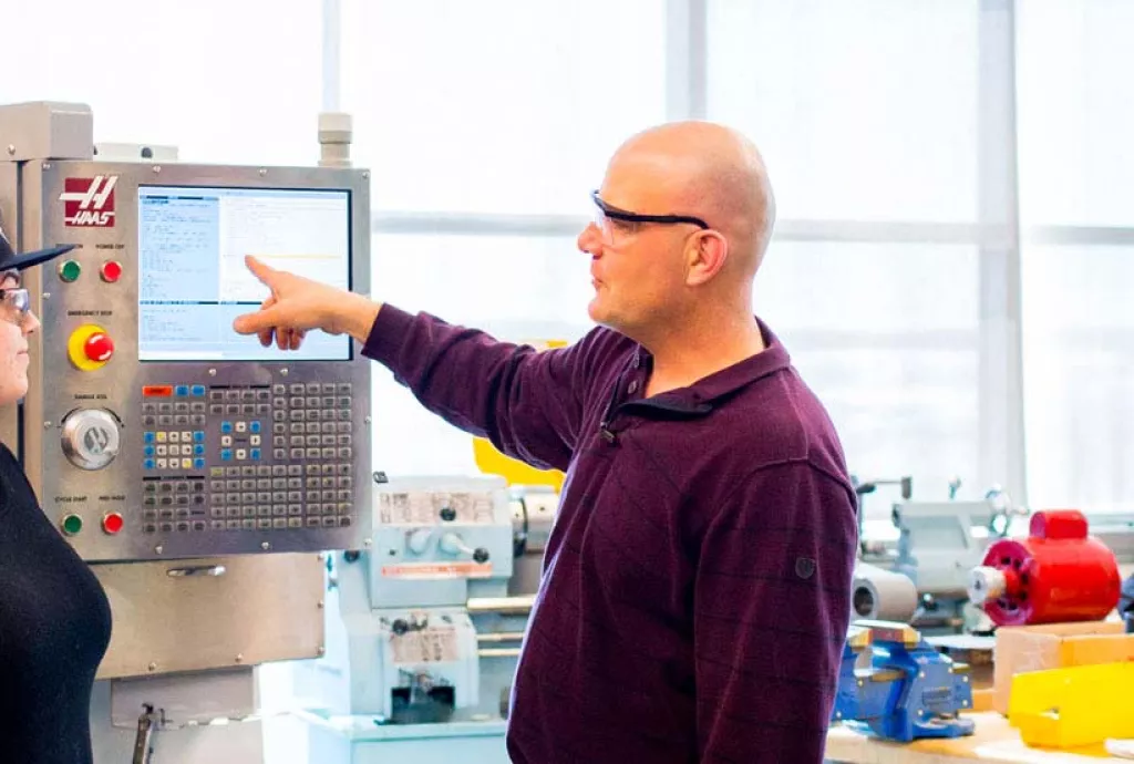 photo - students and faculty in the aerospace manufacturing lab