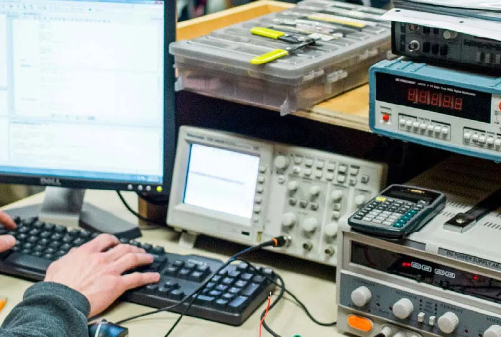 photo - student coding logic at an electronics workstation