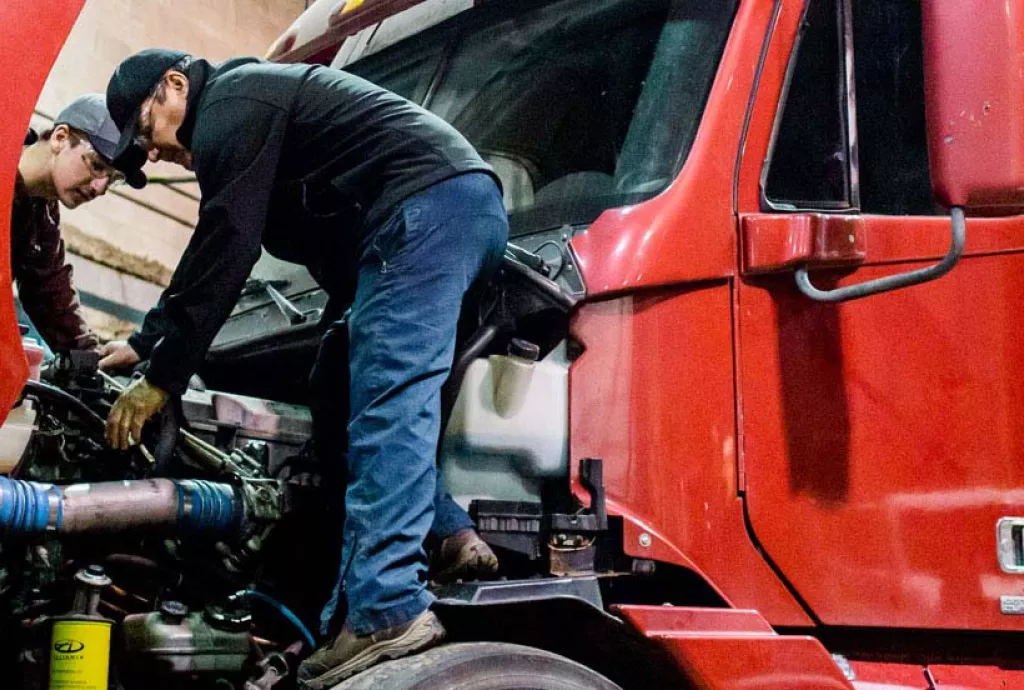 photo - students working on a 18 wheeler truck engine