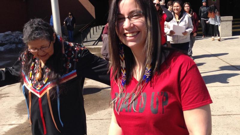 Alumni Ashley Nurmela (right) leads a silent walk as part of the Stand Up Against Racism protest