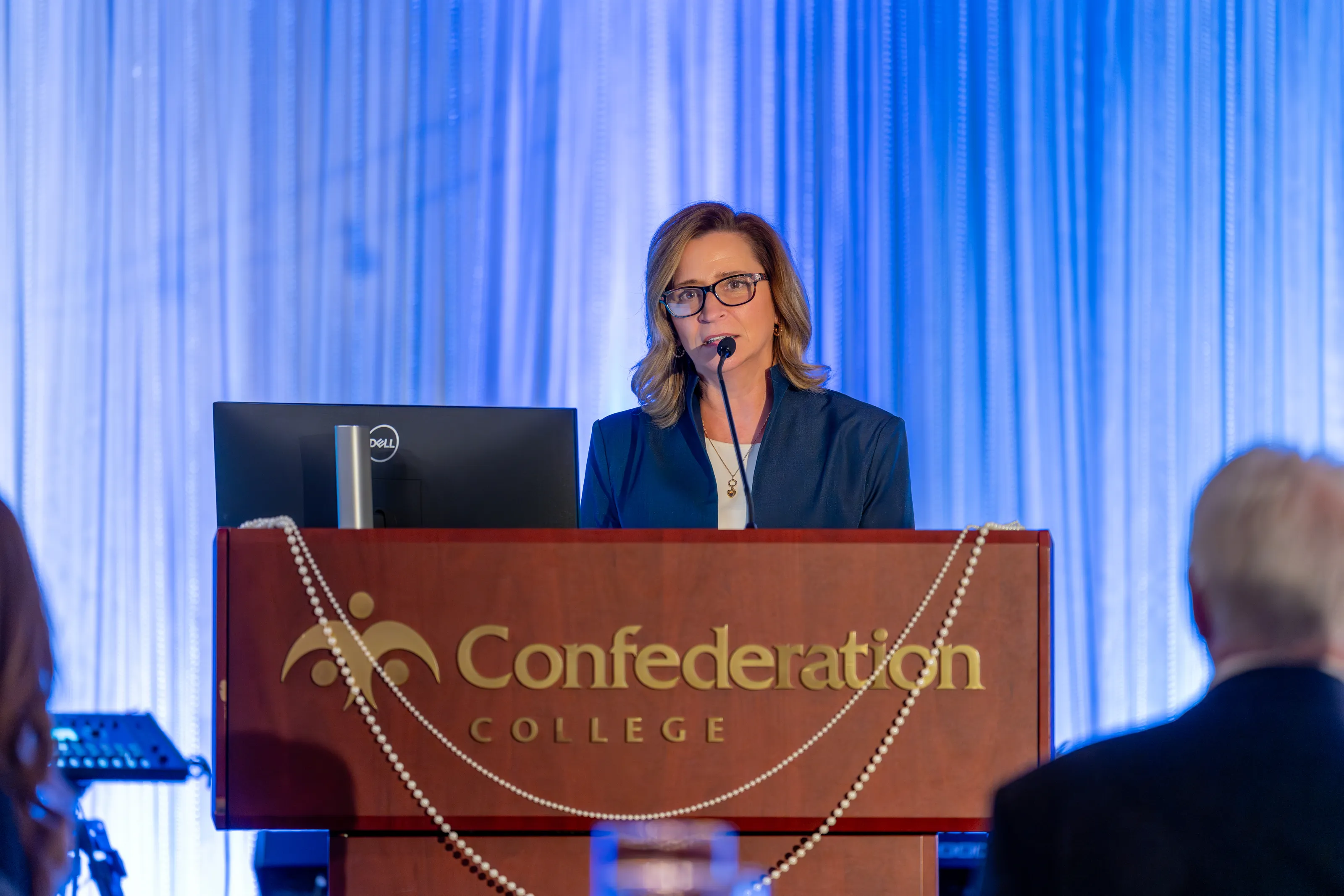 Michelle Salo speaking at a Confederation College podium
