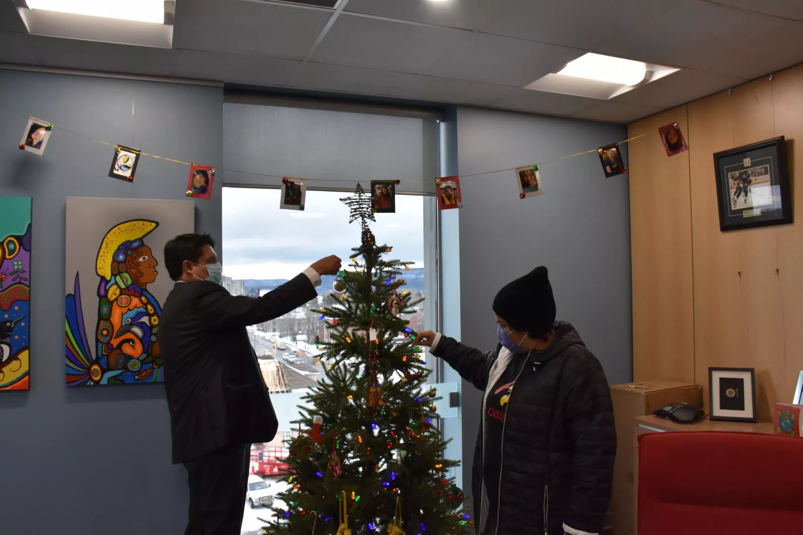 Students hang ornaments with the Grand Chief.