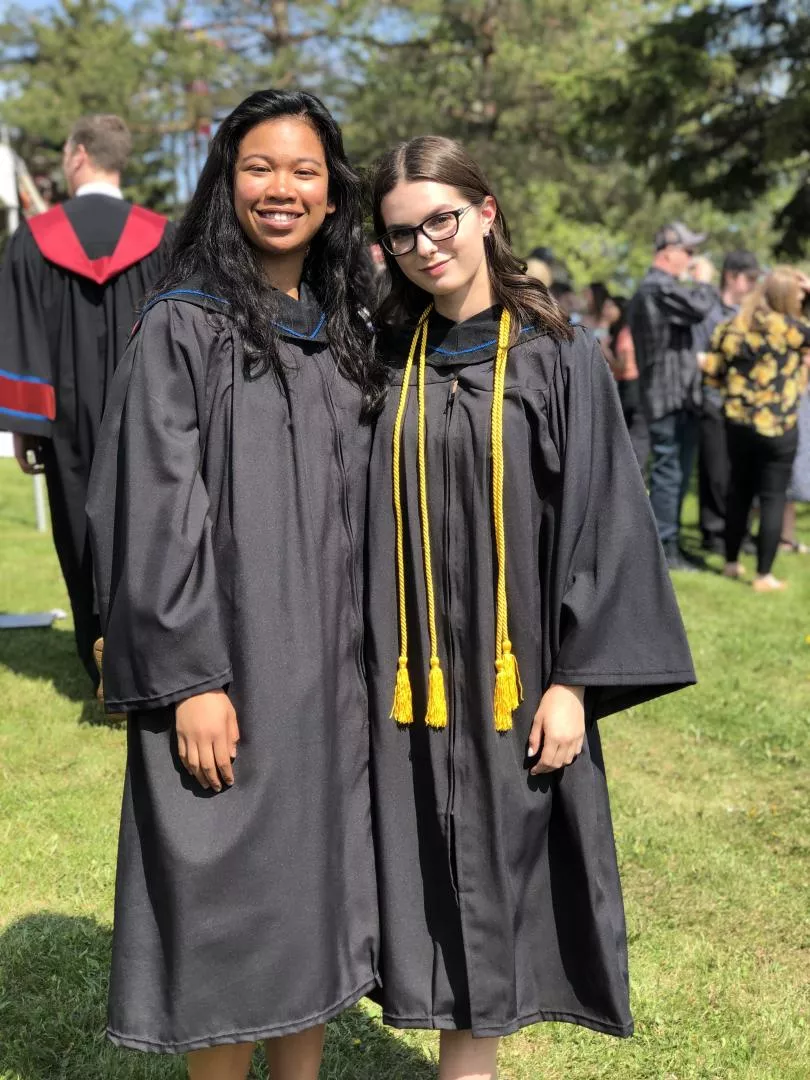 PSW alumna Sarah Pecore (right) with fellow alumna Ruth Oriendo at their graduation